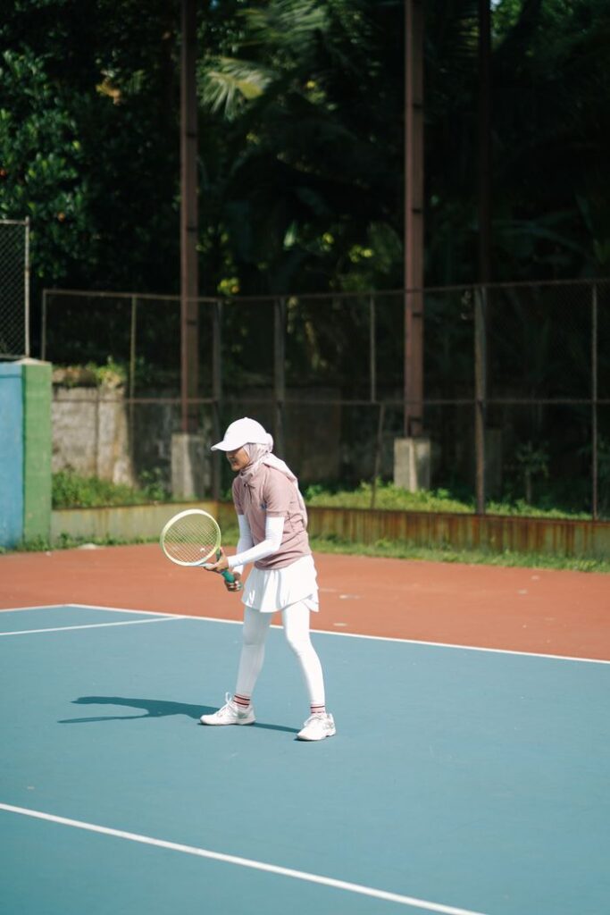 Focused young tennis player on an outdoor court ready to play.